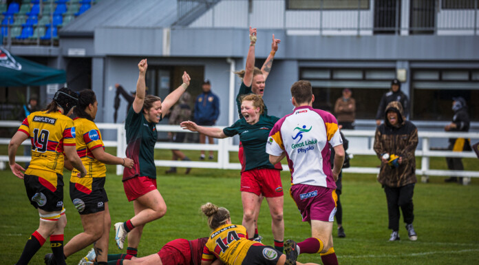 Wairarapa-Bush players celebrate captain Lisa Te Moananui, obscured, scoring the match-winning try over Thames Valley. PHOTO/JADE CVETKOV