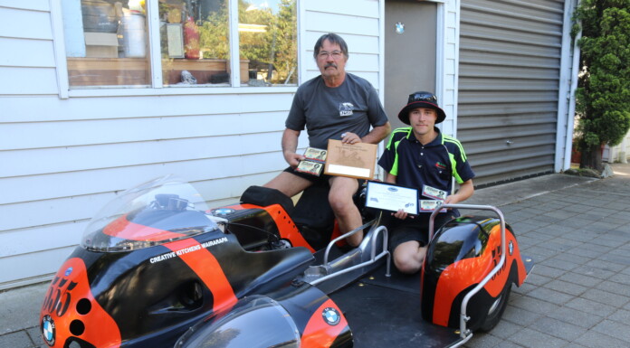 Mark Smith [left] and Isaac Taylor show off their spoils from the Classic Motorcycle Racing Festival at Manfeild. PHOTO/SUPPLIED